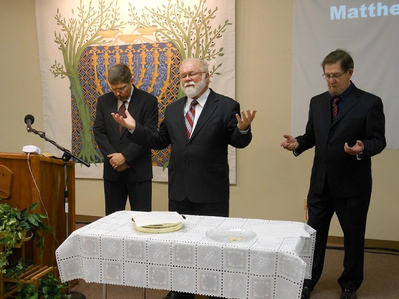 Elder John offering prayer during Passover