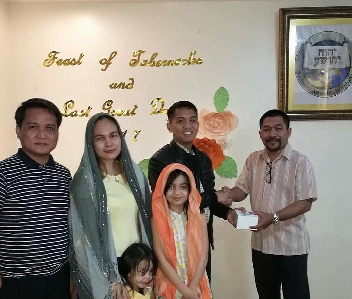 Bro. Carlo giving FOT cup to  baptized member Bro. Baguio, a pastor from Methodist church